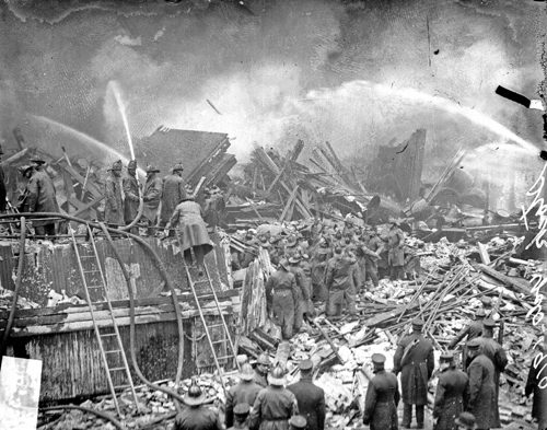 Firefighters in the rubble of Nelson Morris Beef Plant No. 7 directing streams into the collapsed packinghouse.